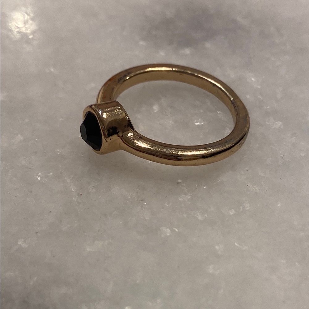 Black faceted stone and gold colored ring approx size 8.5-9